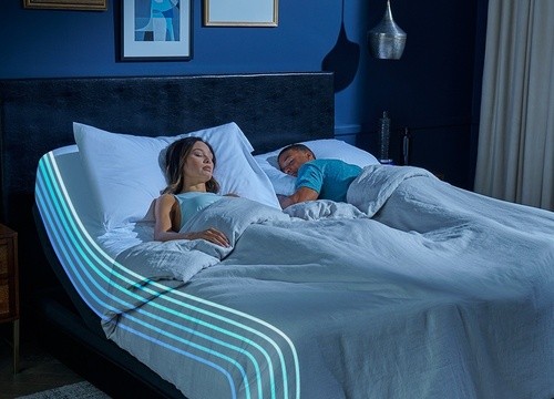 couple laying on a split king Breeze mattress