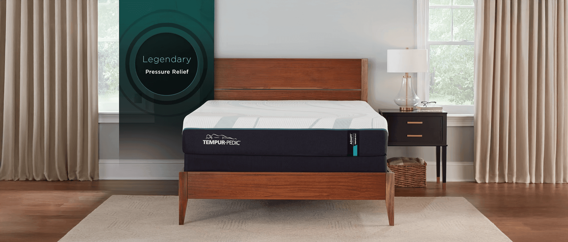 A bare Adapt mattress in a styled room with a banner to the left that says, "legendary pressure relief"