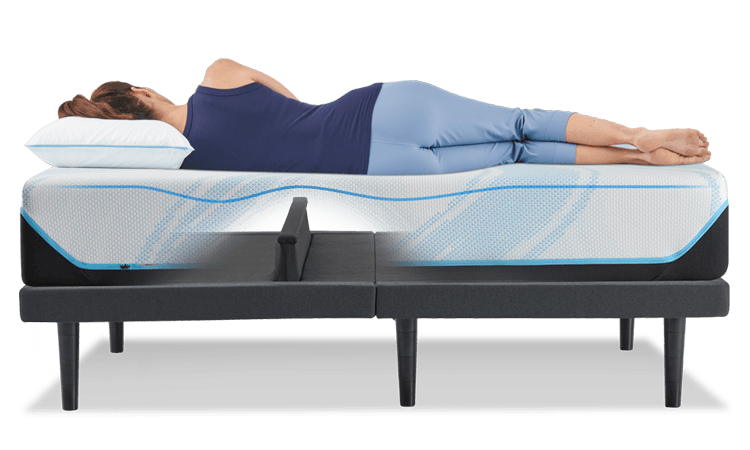 A woman laying on an Ergo Base with the Lumbar Support feature raised
