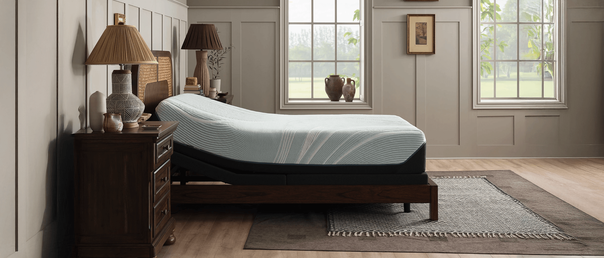zoomed out, side view, of the ProAdapt mattress on an adjustable base with the head of the mattress lifted up in a bedframe