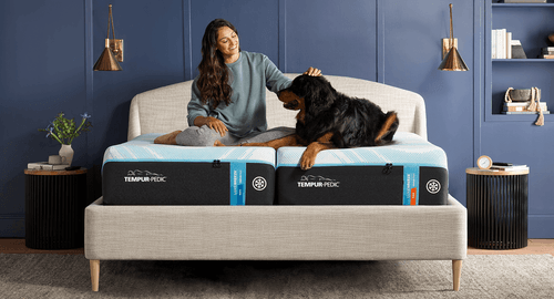 Woman petting dog on Tempur Breeze Mattress