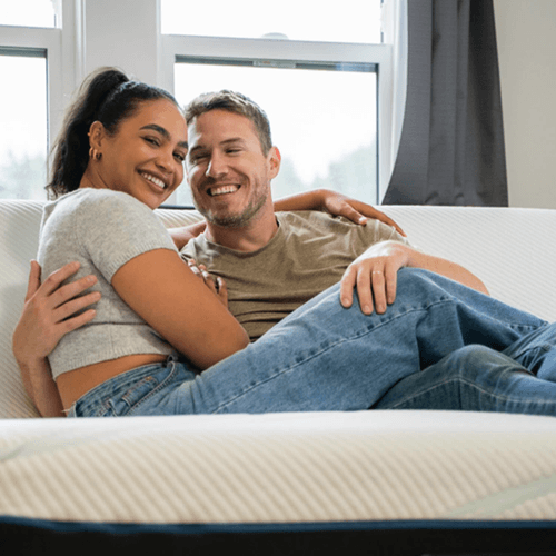 Man and woman sitting on a mattress