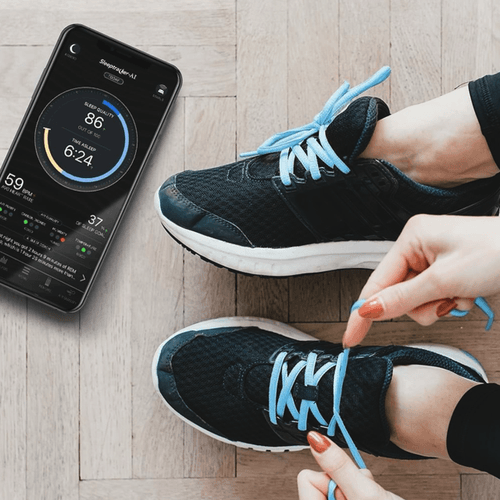 Sleeptracker app on phone screen while tying shoes